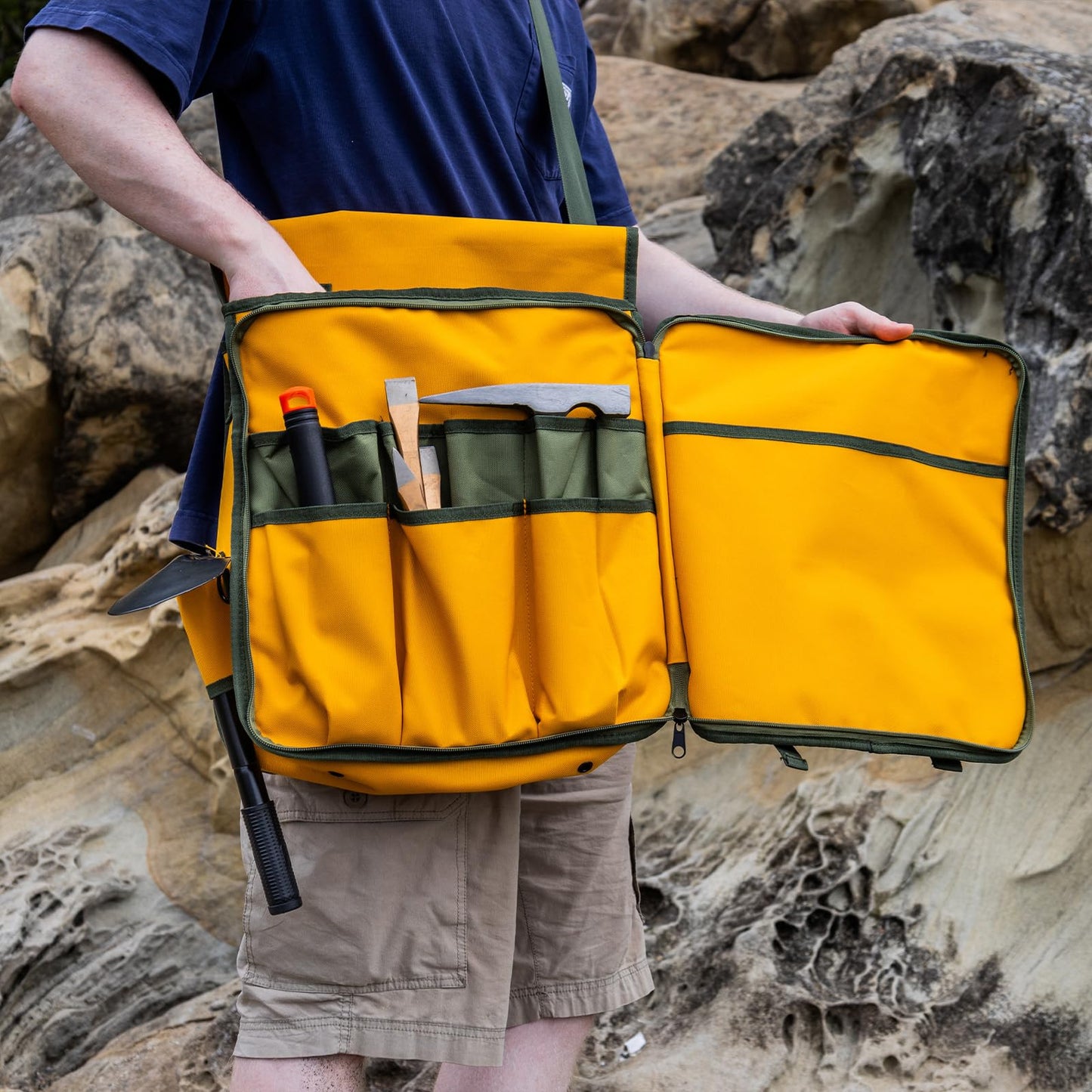Rock hounding bag with many compartments and pockets