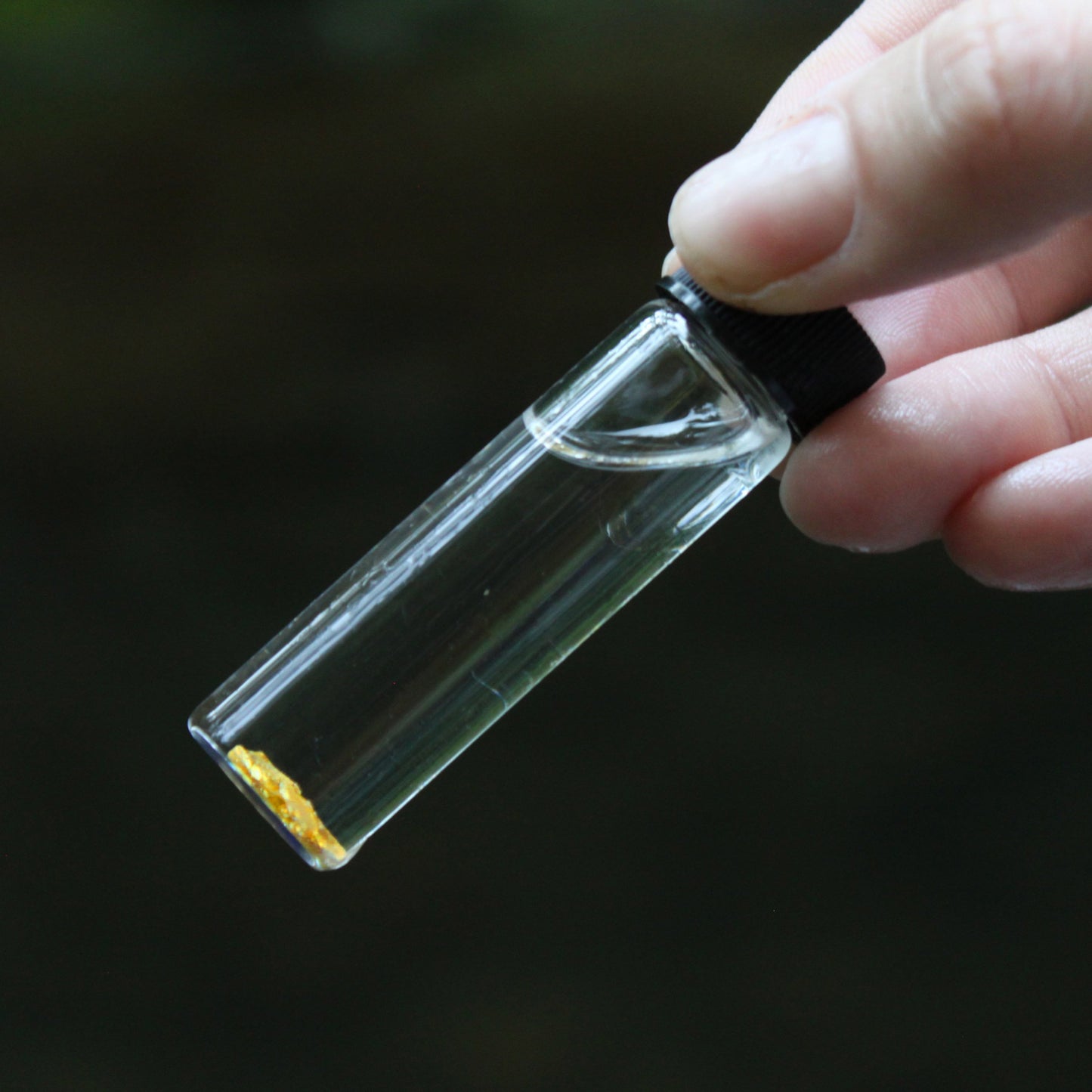 glass vial containing gold gold vial