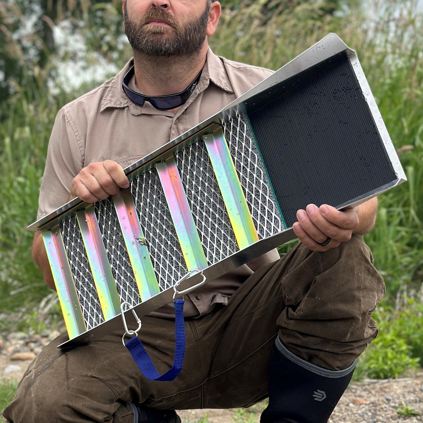 Man holding a colorful compact aluminum sluice box 27 inch
