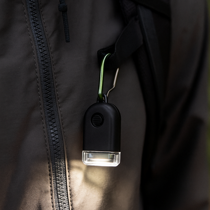Compact 50-lumen mini zipper light with a keychain for camping and EDC (view 1).