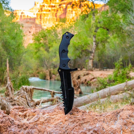 scenic view of tactical huntsman knife in grand canyon by a river