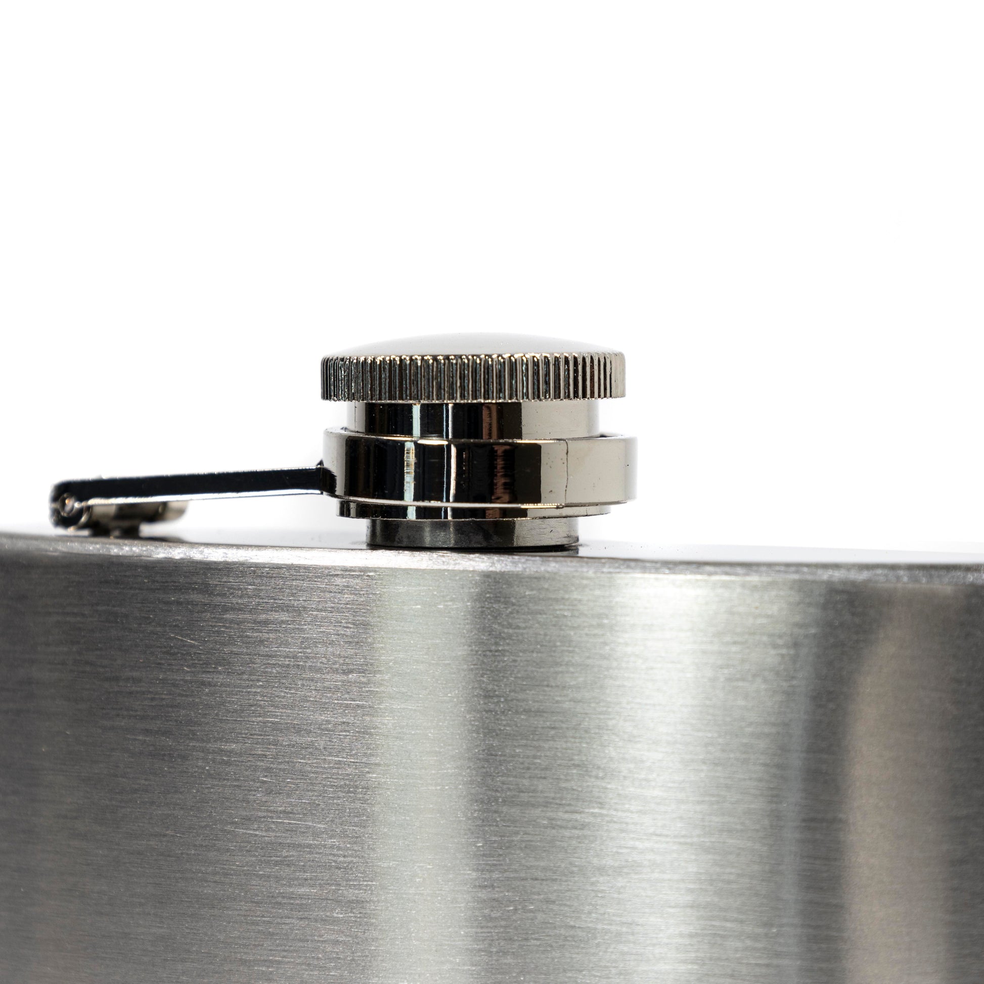 Close-up of a silver flask with a cap on a white background