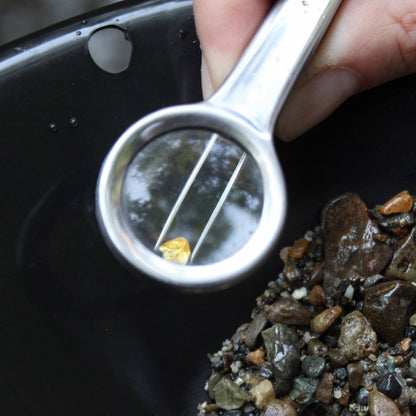 inspecting gold nuggets while gold panning