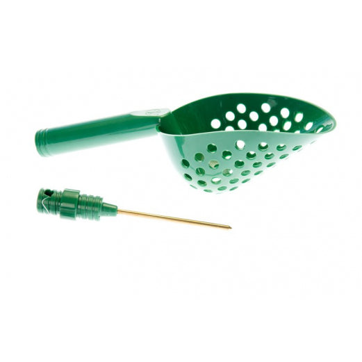 Green plastic scoop with holes and a small magnetic tool