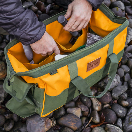 lifestyle real world picture of rock hounding kit on the beach tool bag breaking open rocks geology